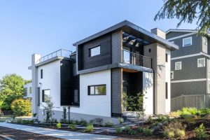 Side elevation of a zero-energy Passive House in Madison Park with James Hardie panel siding and airtight exterior envelope construction.