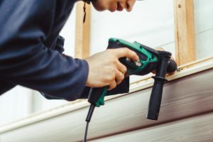Picture of a person installing siding.