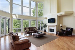 Living room in luxury home witih two story windows