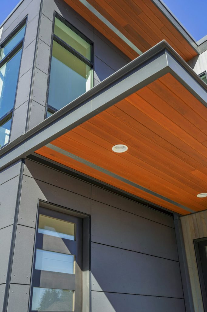 Architectural exterior featuring Equitone panels, stone façade, large glazing systems, and precision waterproofing details installed by Synapse Construction on a high-end custom home in Black Diamond, WA.