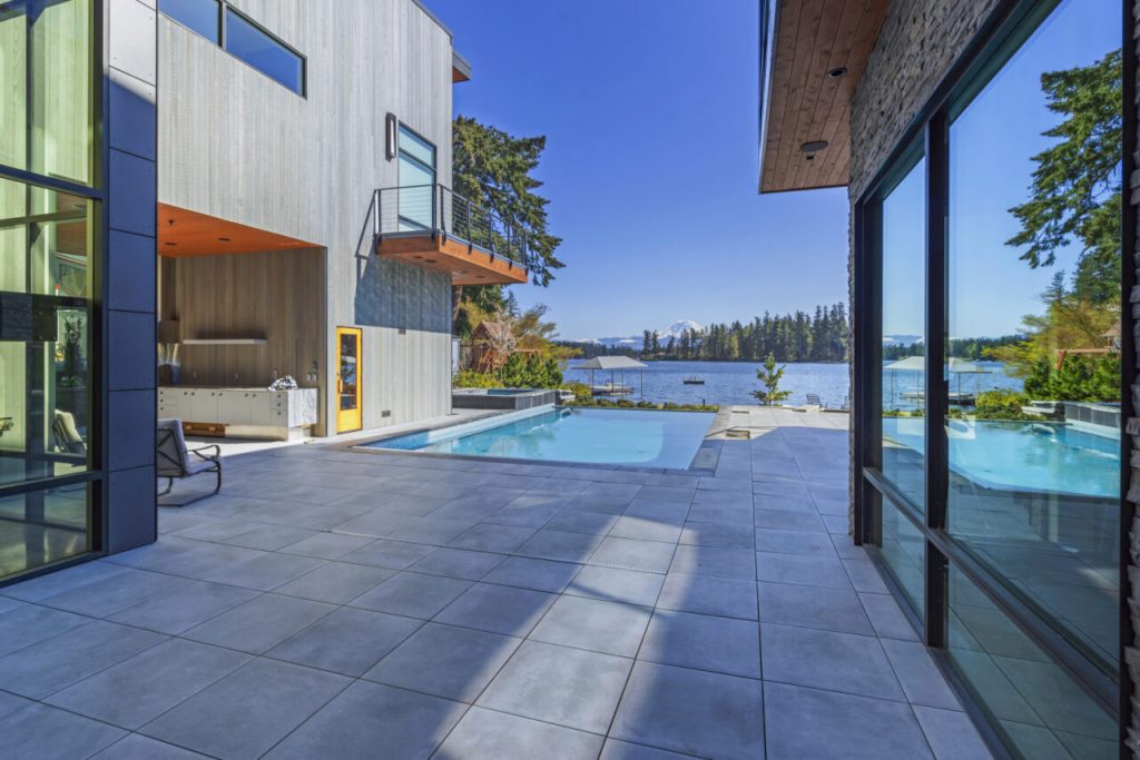 Modern lakeside residence with Equitone fiber-cement panels, Hardie board-and-batten siding, and clear cedar soffits installed by Synapse Construction as part of a complete building envelope system in Black Diamond, WA.