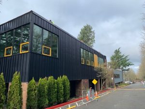 Completed Eastside Prep Middle School building in Bellevue featuring custom-finished steel panel siding, integrated windows, and a modern commercial exterior envelope.