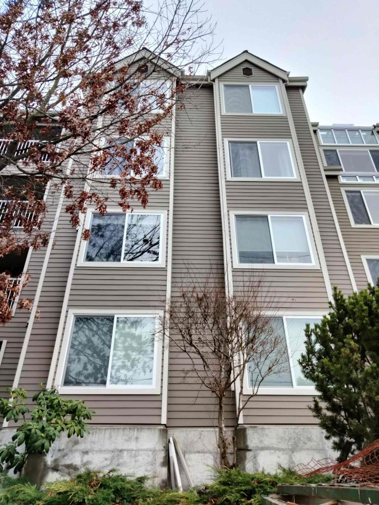 Completed condo exterior renewal featuring James Hardie plank siding, primed finger-joint cedar trim, Milgard vinyl windows, Crystalite Skywalls, TPO roofing, and full repainting by Synapse Construction in Queen Anne, Seattle.