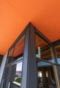Ballard Seattle mixed-use building featuring wood soffits, fiber cement siding, metal trim, and modern façade detailing installed by Synapse Construction.