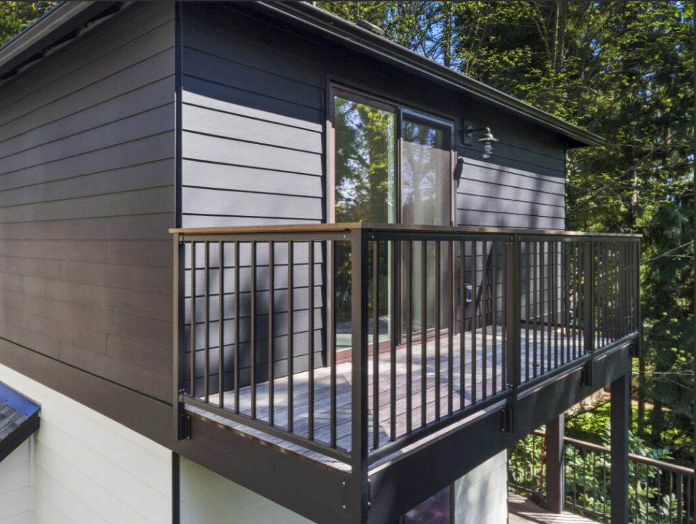Elevated deck constructed over living space with waterproofing membrane and proper deck-to-wall detailing to prevent water intrusion in a Seattle-area home.